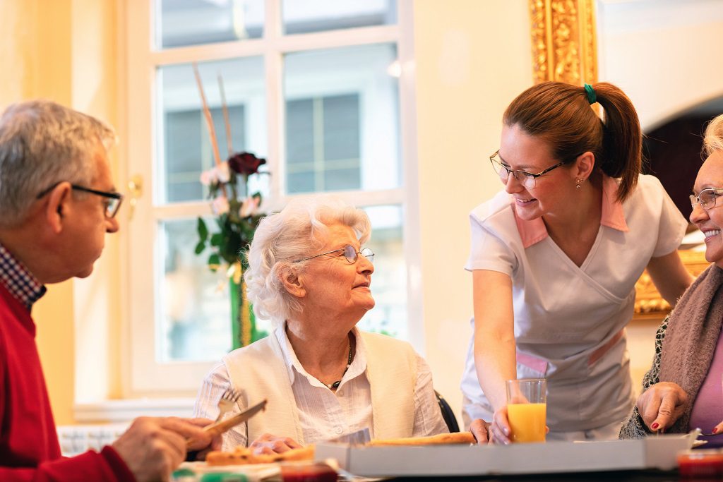 Occupants of the nursing home accompanied by the personnel while having dinner